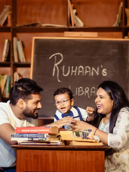 Learning is a family affair. I love capturing candid interactions, like this moment of shared laughter during a creative "little scholar" themed family photoshoot.
