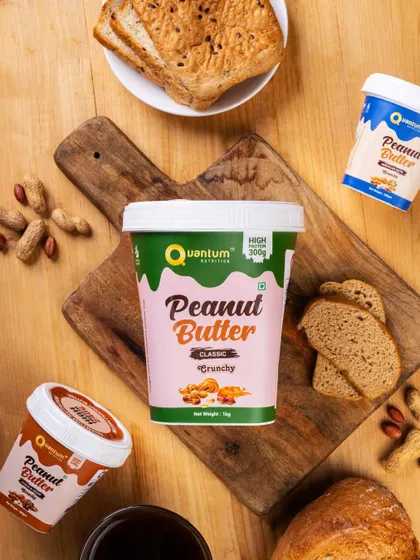 A flat lay of Quantum Nutrition's classic peanut butter, styled as part of a healthy breakfast. This lifestyle shot shows the product in a relatable, everyday context.