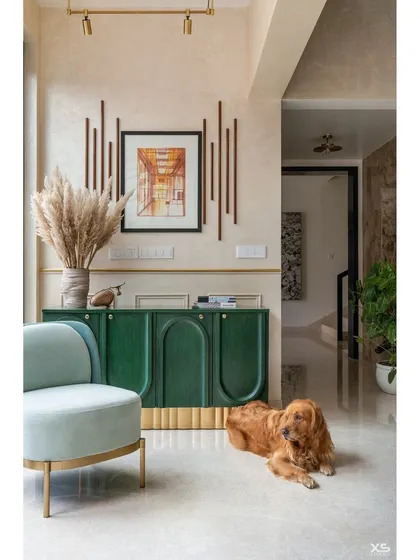 Another view of the foyer, where the soft mint green armchair and textured wall create a serene entry point into the home.