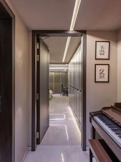 A duplicate of image 27, this view emphasizes the corridor as a gallery space. The linear ceiling lights guide the eye through the home, connecting the public and private areas.