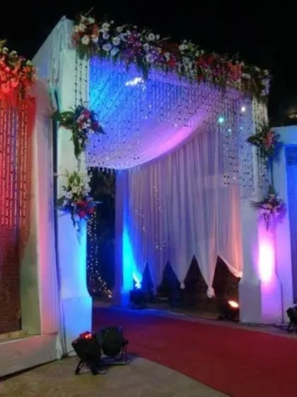 The entrance to the outdoor reception, decorated with colorful lighting and drapery to create an exciting entry point for guests.