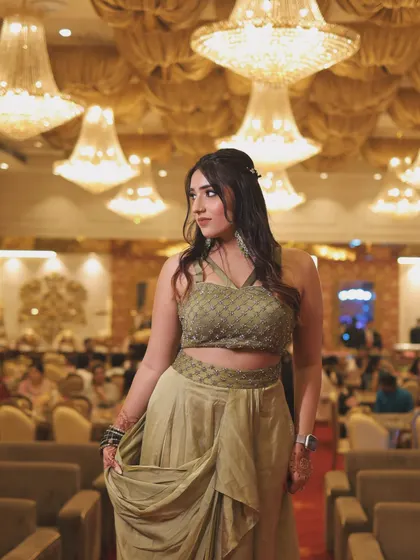 A full-length shot of the olive green outfit. This showcases the unique cut and drape of the modern ethnic wear.