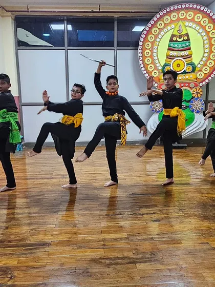 A line of young boys practicing a synchronized leg-hold from Chhau dance. Discipline and coordination are key skills taught in my classes.