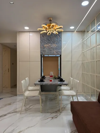 A frontal view of the space-saving dining unit, shown here in its compact form. The design includes integrated storage and is crowned by a modern fan-style chandelier.