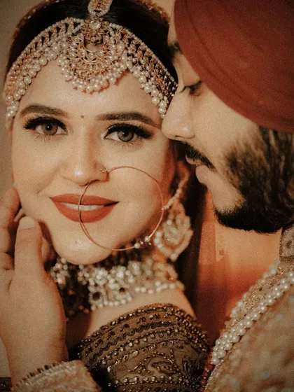 A stunning close-up of the couple, the groom's gentle touch on the bride's face highlighting their intimacy and love.