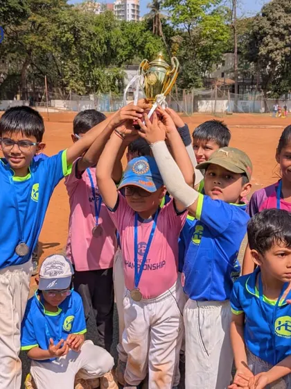 The pure elation of a team victory. Our junior players celebrate together after a successful tournament, learning the value of teamwork and shared achievement.