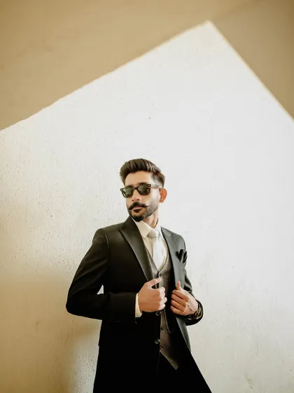 A cool and stylish portrait of the groom in sunglasses. This shot shows off his personality and adds a modern edge to the wedding album.