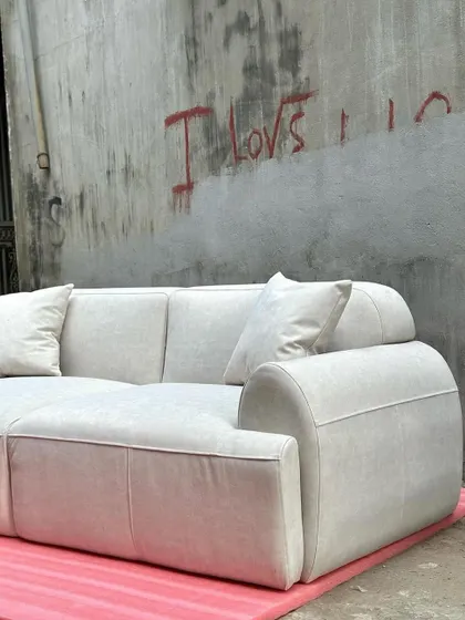 An angled view of the minimalist sofa, emphasizing its deep seats and comfortable, modern form.