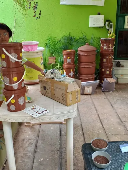 A young participant curiously inspects the composting setup before a workshop begins. We believe it's never too early to learn about our responsibility to the environment.