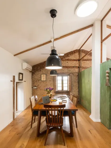 The main meeting and dining table in our studio. The exposed brick wall and original wooden beams create a warm, rustic backdrop for our team gatherings. It’s a space that feels both professional and deeply personal.