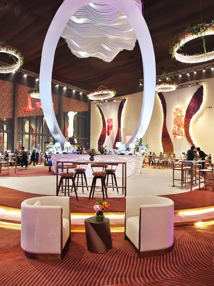 An expansive view of a corporate event setup, designed around magnificent central structures. Our team is experienced in planning and executing food service for events of any scale, ensuring smooth flow and guest satisfaction.