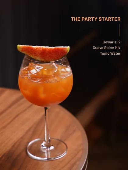 The Party Starter, a vibrant guava and spice mix cocktail with tonic water, designed to get your evening going.