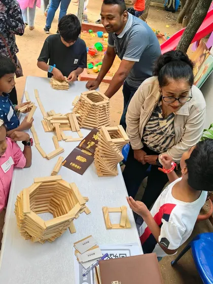 The energy at our events is always buzzing with creativity and collaboration. Here you can see children and parents all deeply engaged, sharing a table but each exploring their own ideas. This is a community of builders, learning from and being inspired by one another.