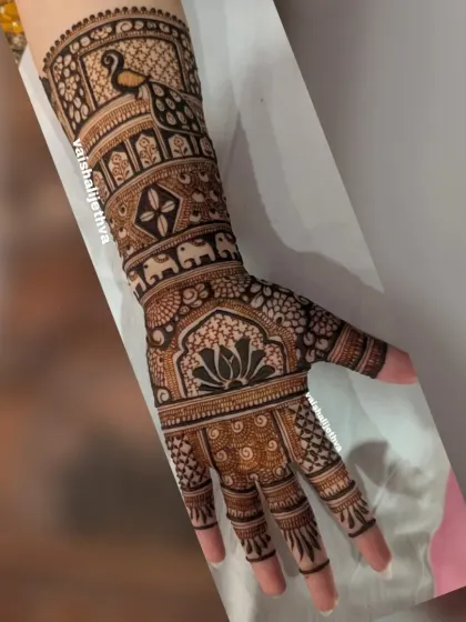 A beautiful single-hand design with multiple traditional motifs. It includes a peacock, elephant, and lotus, all expertly woven into a cohesive pattern.