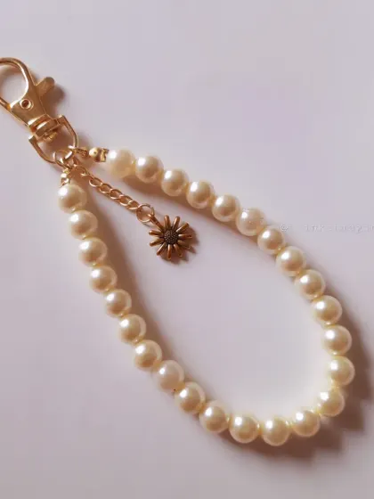 This is a simple pearl and sun charm bracelet, but it represents my brand's core: cute, unique, and handmade accessories for every occasion.