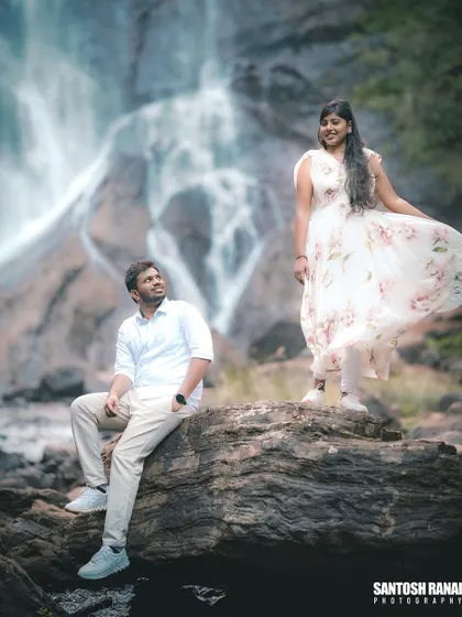A relaxed and scenic portrait of the couple enjoying the natural beauty of the waterfall location.