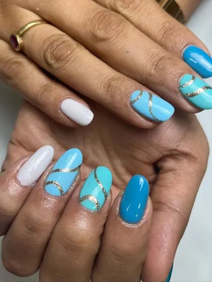 How about some blue hues with a sparkly twist? This design features different shades of blue, with gold glittery lines adding a touch of glamour.