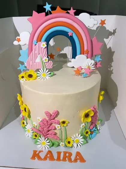 Brighten up any birthday with this cheerful rainbow and flowers cake. The colourful fondant rainbow and variety of flowers make this a vibrant and happy design, perfect for a 4th birthday party.
