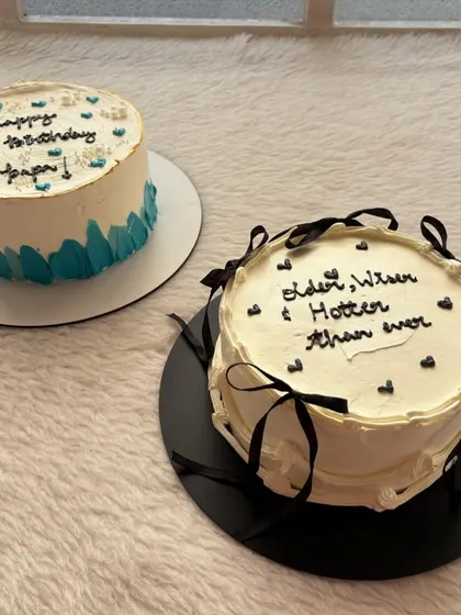 Two birthday cakes, one for a papa and another with a fun "Older, Wiser & Hotter than ever" message.