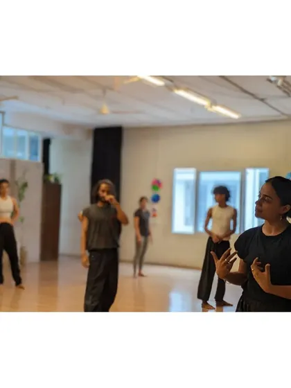 An instructor explains a concept to the class, fostering an environment of learning and understanding.