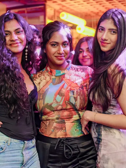 The diverse and stylish crowd that makes every VIBE CHECK unique. A group of friends enjoying the party.