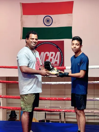 Another student receiving his reward for his excellent performance.