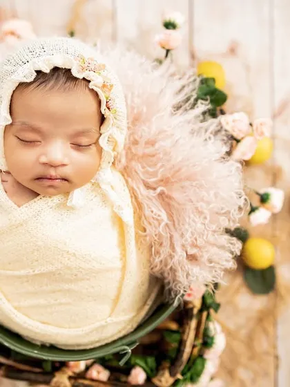 Such a vintage beauty, all tucked in with a delicate bonnet and surrounded by soft florals. I carefully style each shot to create a unique and artistic newborn portrait.