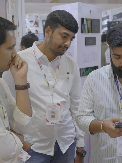 A moment from the expo floor, showing a visitor our mobile app. The hands-on experience is what makes these events so valuable.