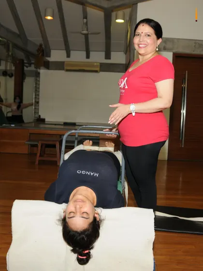 Pain can turn a positive mind negative. A simple supported backbend over a chair, as shown here, can be a game changer. It helps to open the chest, improve posture, and calm the nervous system, which is a critical part of the healing process in my medical classes.
