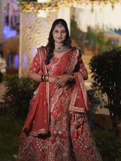A complete view of Amrutha's stunning reception lehenga and makeup. The entire look is coordinated to create a feeling of royal elegance.