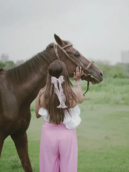 Another perspective of a rider and her horse, emphasizing the calm and gentle nature of their interaction.
