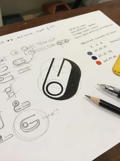 My design process begins with pencil and paper, not pixels. This image shows the initial brainstorming and geometric structuring for the Gwel Tech LLP logo, exploring how the letter 'G' could be visualized as a projector, moving from rough concepts to a refined, calculated form.