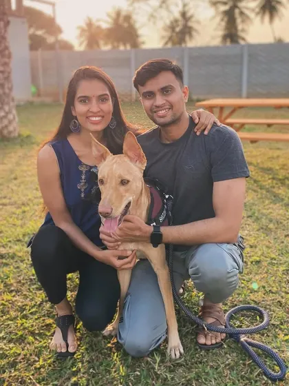 A happy couple with their beautiful indie dog, a perfect family portrait at the camp.
