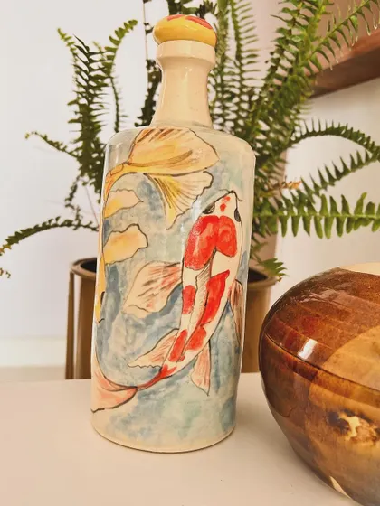 A hand-painted vase with koi fish. The process of painting on pottery is so therapeutic and allows me to combine my love for drawing and clay.