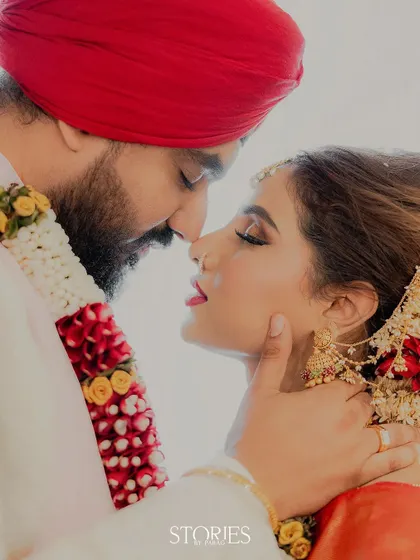 An intimate and tender moment between a couple after their wedding ceremony at the ISKCON temple. The groom's touch and their closeness convey a sense of peace and deep connection.