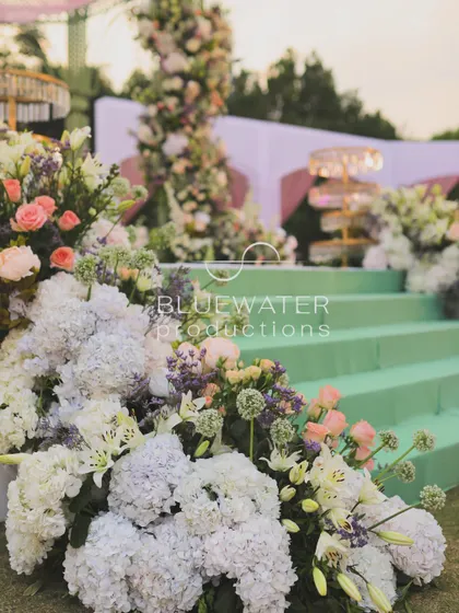 Flowers cascade down the steps leading to the mandap, creating a seamless floral carpet.