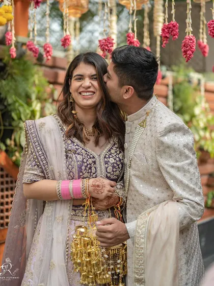 A sweet kiss from the groom after the ceremony. A perfect, happy moment from their intimate 40-person wedding.
