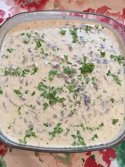 A large glass dish of my creamy mushroom dish, garnished with fresh parsley. This is part of my continental offerings, perfect for when you want some comforting, non-spicy options for your party.