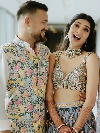 A fun, candid moment from the Sangeet. The bride's expression is priceless, and her makeup is fresh and party-ready.