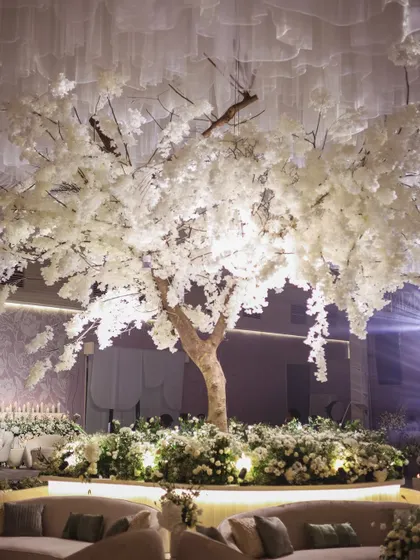 For this all-white reception, I designed a magnificent white tree as the central feature, creating a stunning and magical focal point for the lounge area.