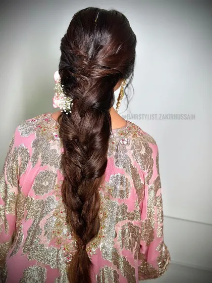 A thick and voluminous classic braid with a twisted crown. This is a timeless and elegant style that can be accessorized with flowers or jewelry.