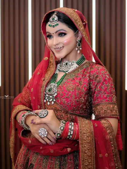 A graceful pose with the bride's hands gently clasped. This shot highlights her beautiful rings and bangles, along with her serene expression.