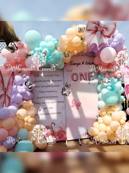 A close-up of the twins' butterfly-themed backdrop, showing the delicate details and the soft, dreamy color palette.
