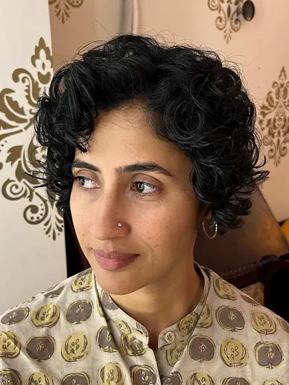A front view of the curly pixie bob, showing how it frames the face.