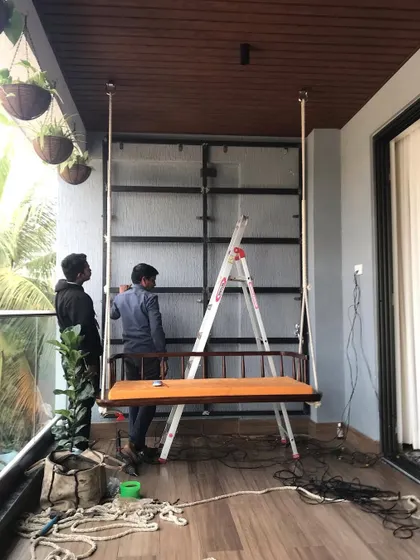 Another view of the installation process for a balcony vertical garden. Our crew is carefully setting up the framework that will support the living wall, ensuring it is secure and ready for planting.