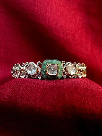 Adorn your wrists with this exquisite polki bracelet, a masterpiece of traditional craftsmanship. Its intricate design and vibrant colors make it a perfect addition to any festive outfit.