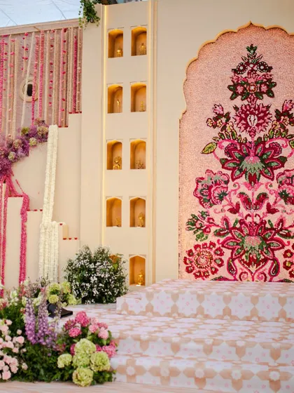 Another angle of the floral mosaic Jaimala stage, highlighting the detailed craftsmanship and the elegant niches with soft lighting that framed the central arch.
