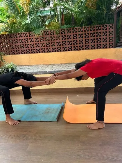 A simple yet effective partner stretch. This forward fold variation allows both partners to get a deeper hamstring and back stretch by using each other's body weight for gentle resistance.