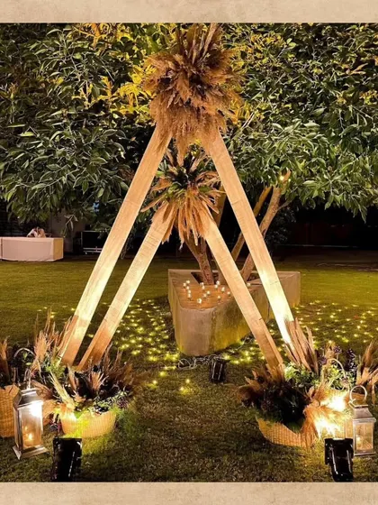 A unique teepee-style photobooth for a boho-themed event. I used wooden beams, pampas grass, and warm lanterns to create a rustic and dreamy corner for guests to capture memories.