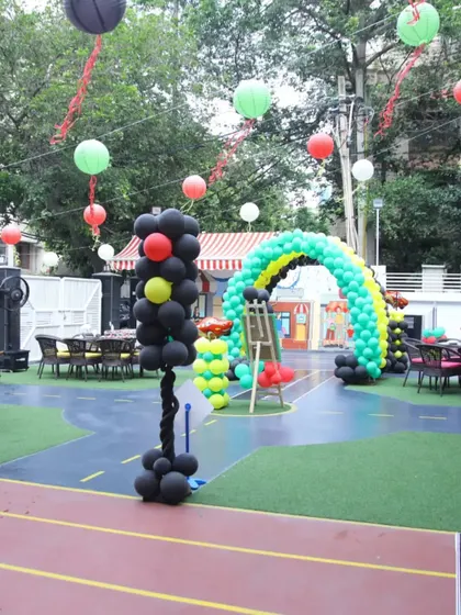 A wide shot showing the layout of the Cars themed party, with seating areas arranged around the central racetrack. It’s all about creating an immersive and fun environment.